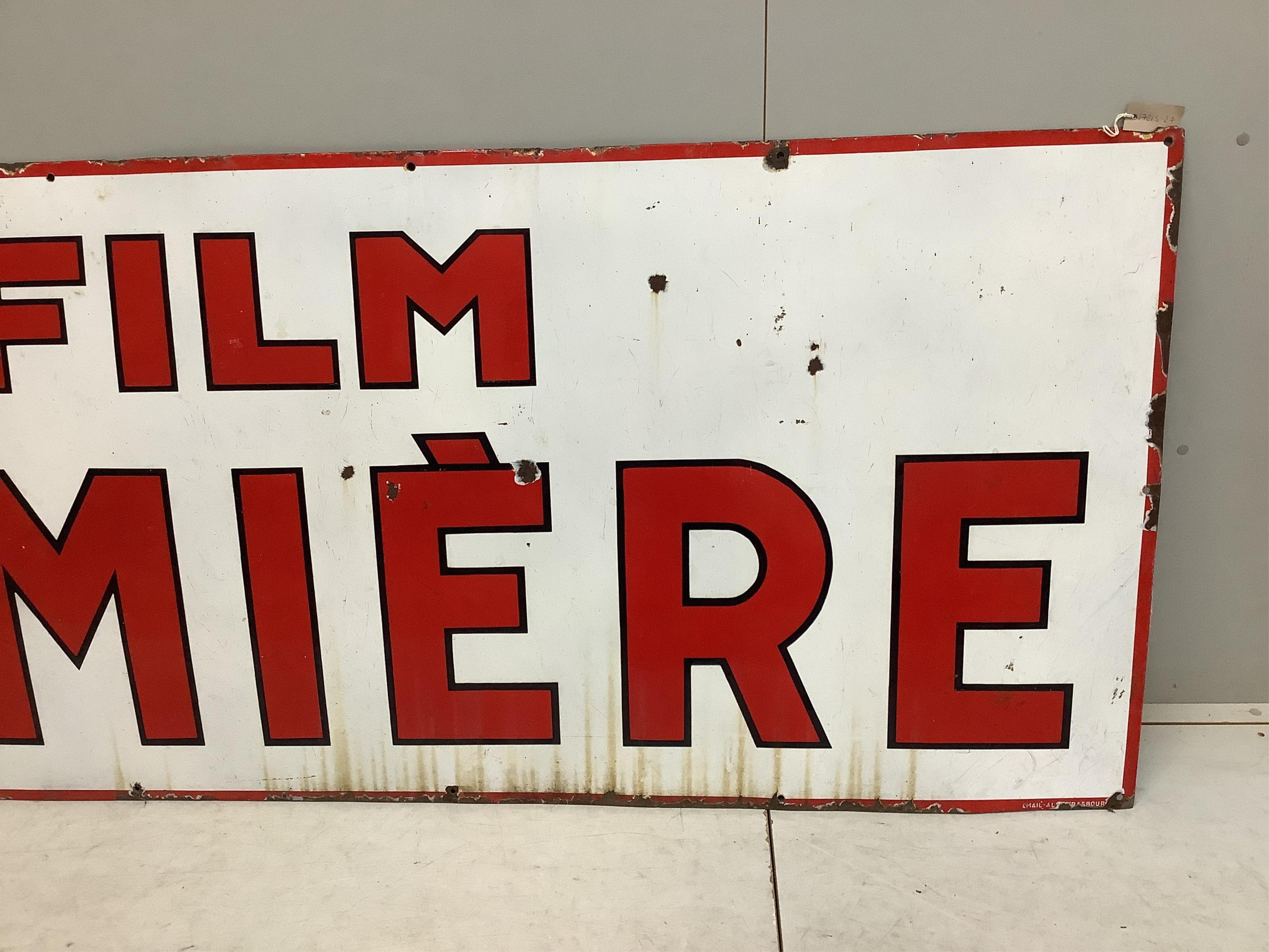 A large vintage French enamel advertising sign 'Film Lumière', width 246cm, height 95cm. Condition - fair